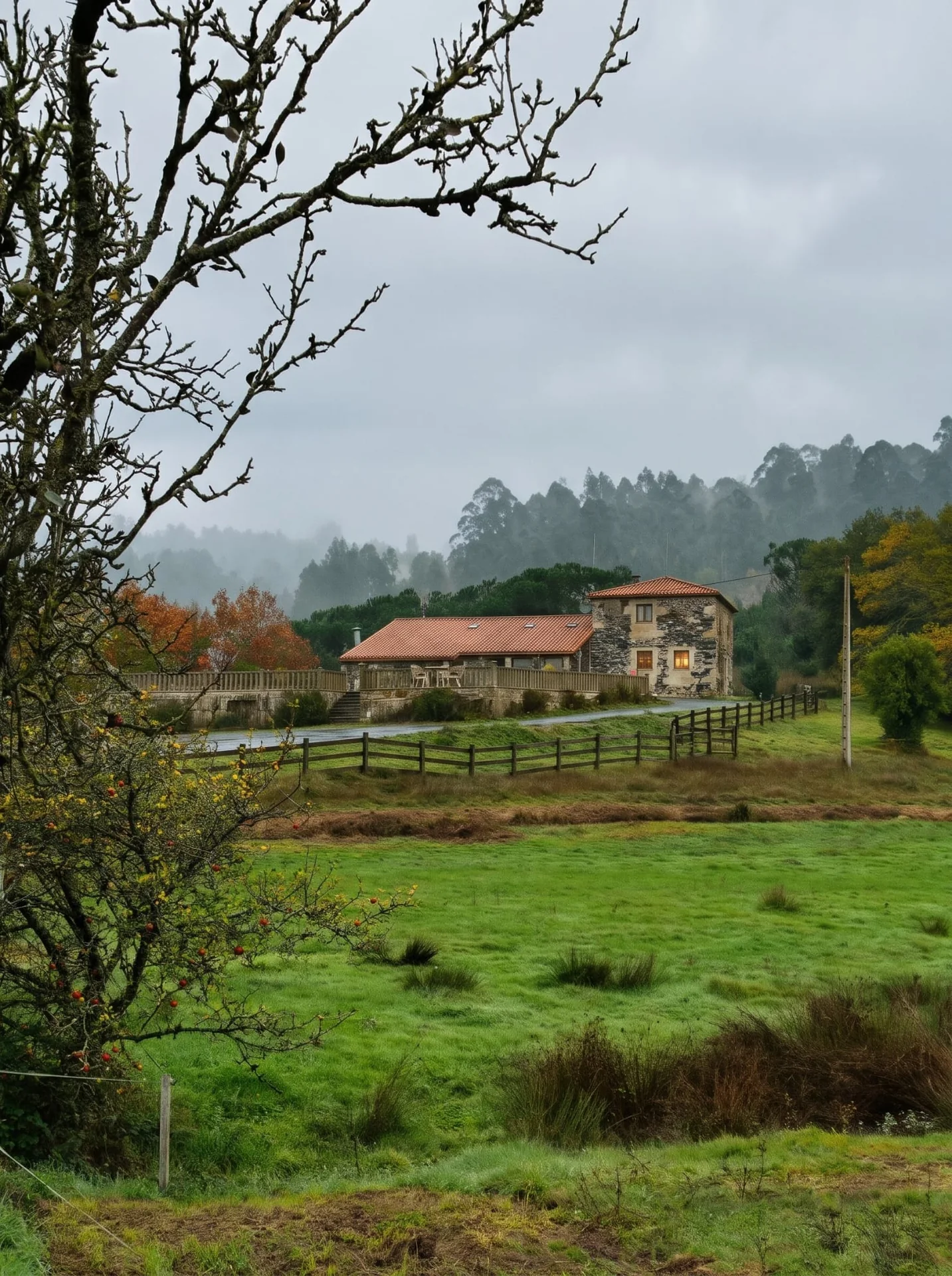 Meadows and stone houses of Porto de Bois under an autumn sky