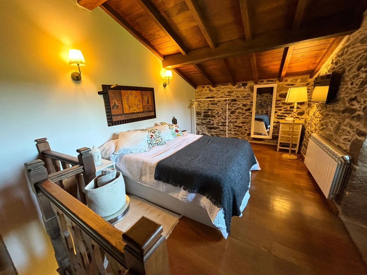 Double bedroom with stone walls and wooden beams